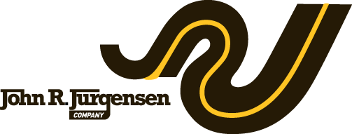 A picture of an icon in the shape of an interstate or highway beside the words John R Jurgensen Company used as a logo for the heavy highway construction company in Cincinnati, OH.